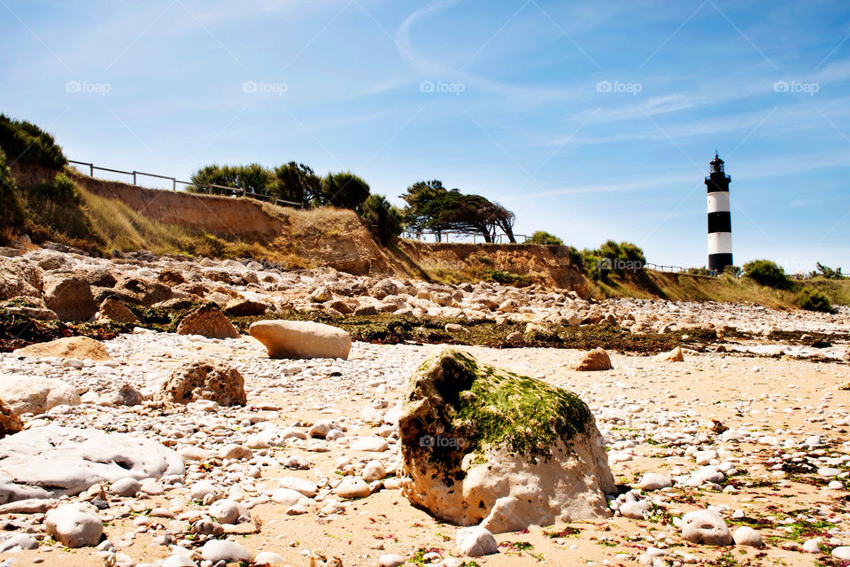 sand rocks lighthouse coast by ilsem16