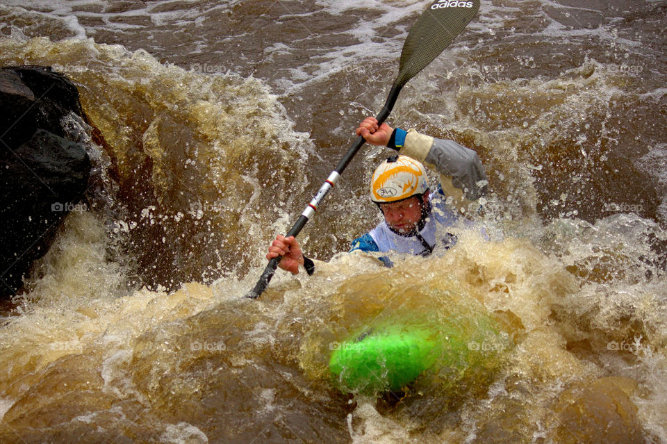 Helsinki, Finland -  April 17, 2016: Unidentified racer at the annual iceBREAK whitewater kayaking competition at the Vanhankaupunginkoski rapids in Helsinki, Finland. 