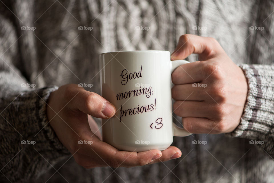 Close up of hands holding big tea cup