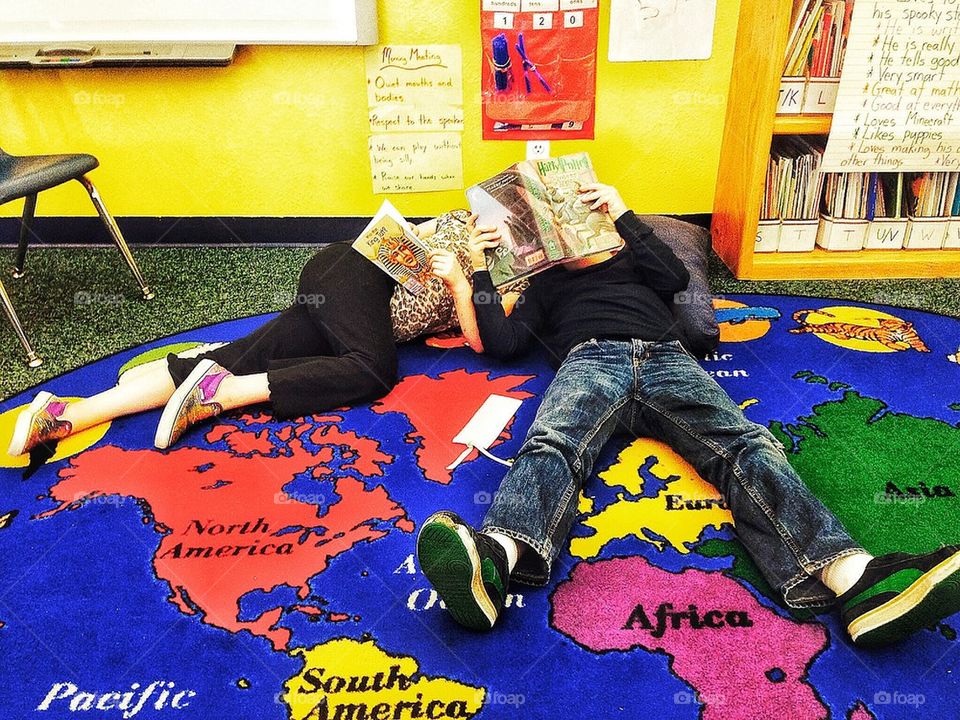 Kids reading a book in classroom 