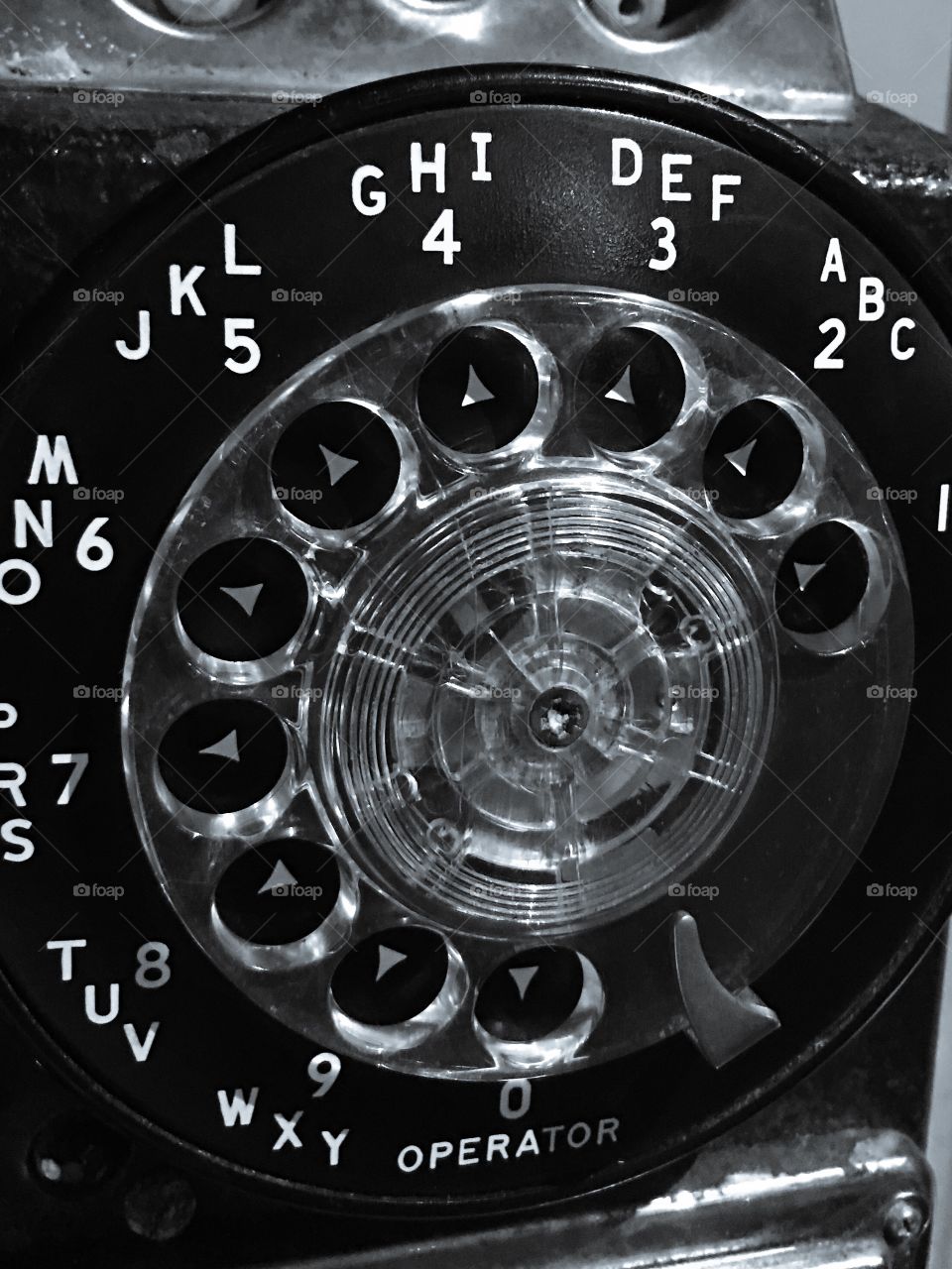 Antique rotary dial telephone in black and white. 