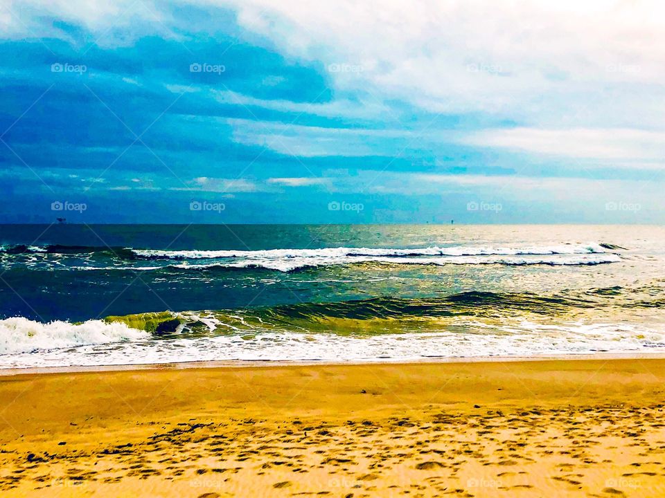 Blue sky with water and warm sand at the beach