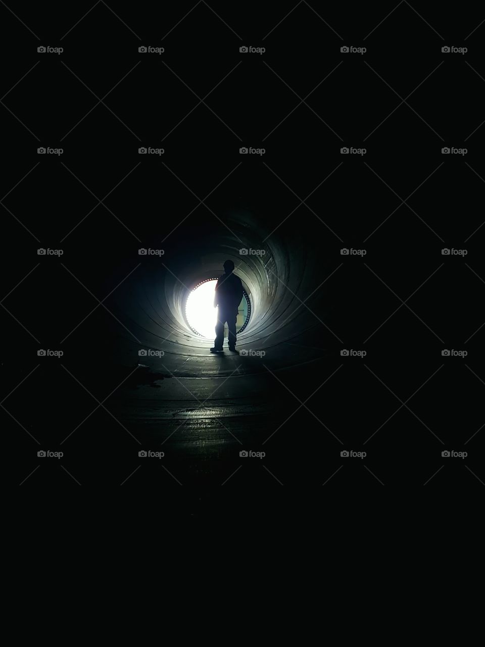 construction worker standing in a big pipe