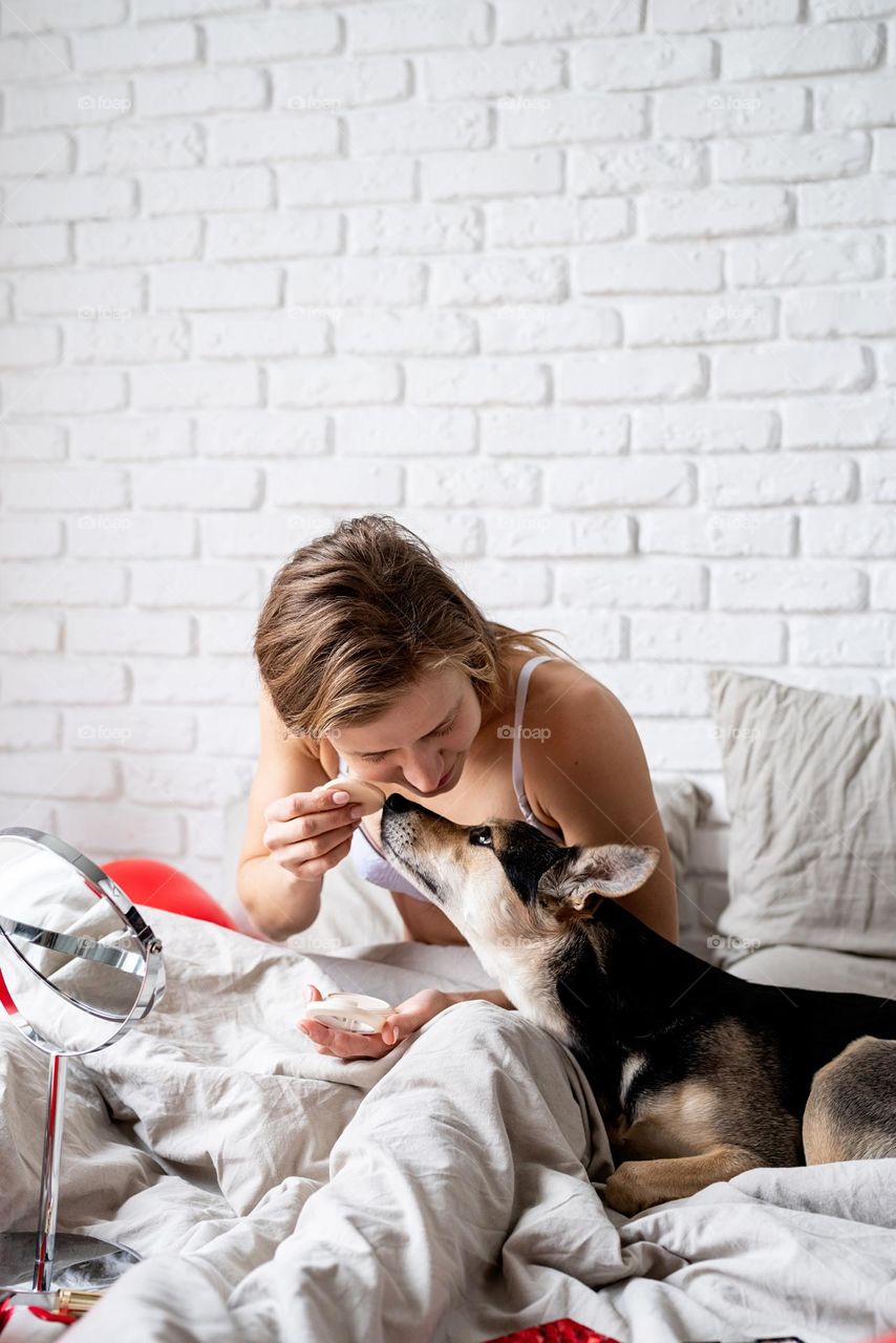 woman using cosmetics at home