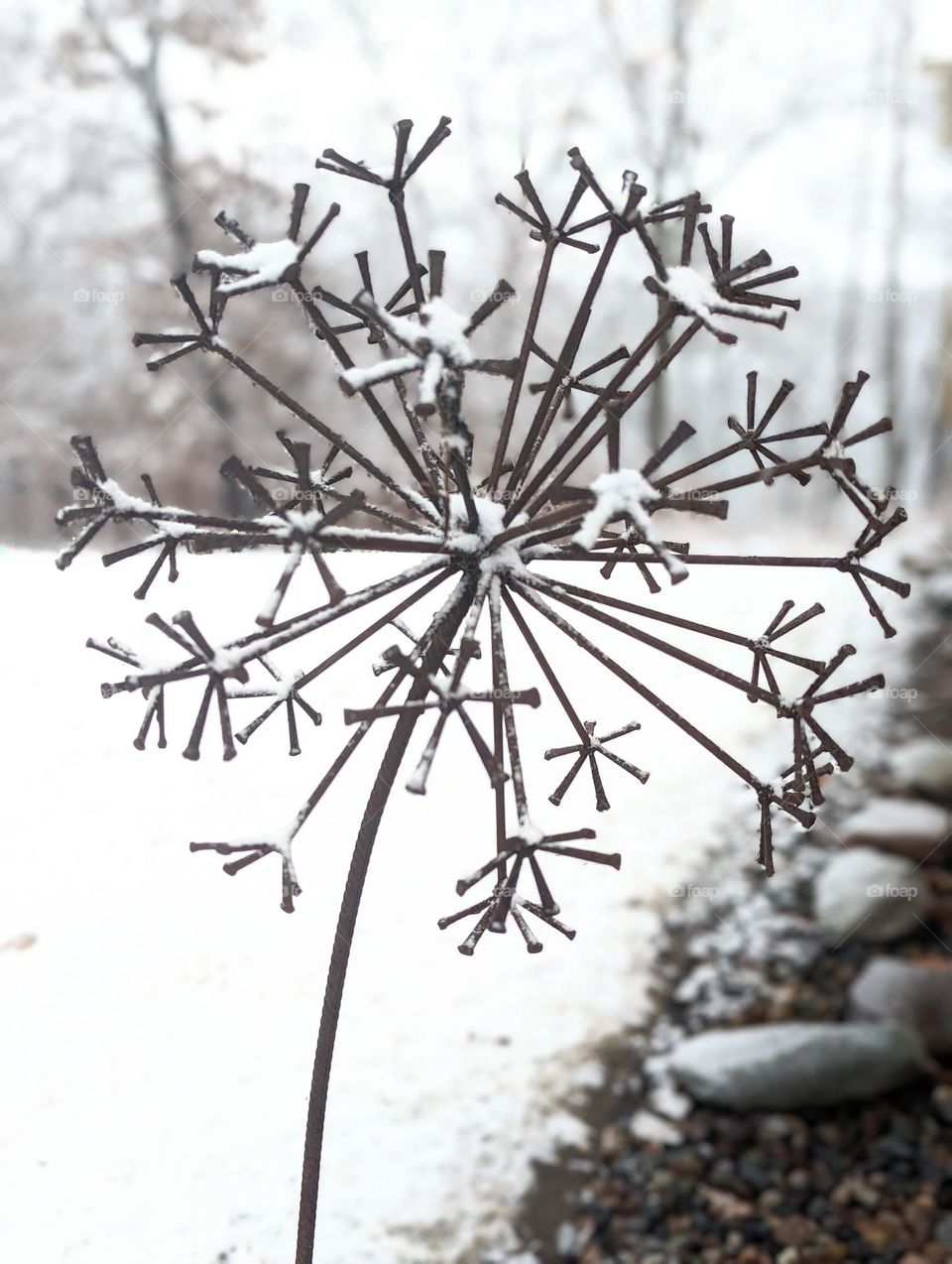 snow covered dandelion statue lawn ornament, fresh snow on outdoor metal dandelion