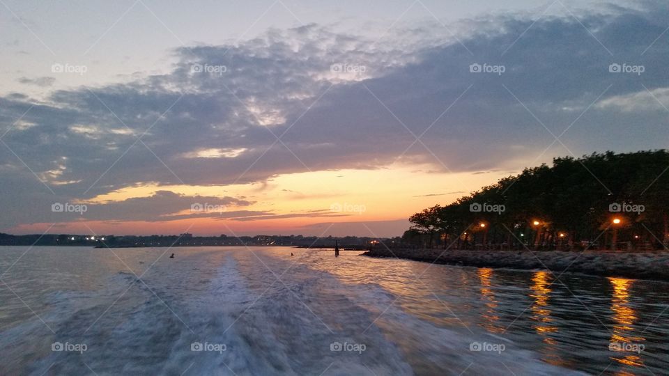 Wake from a boat at sunset