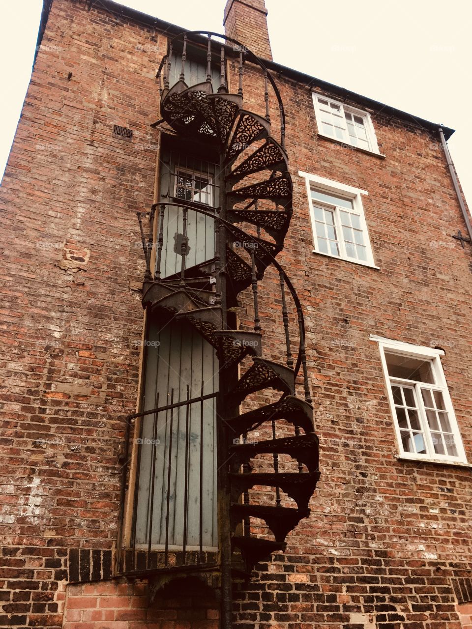 Interesting old riverside brick building with external spiral staircases between floors