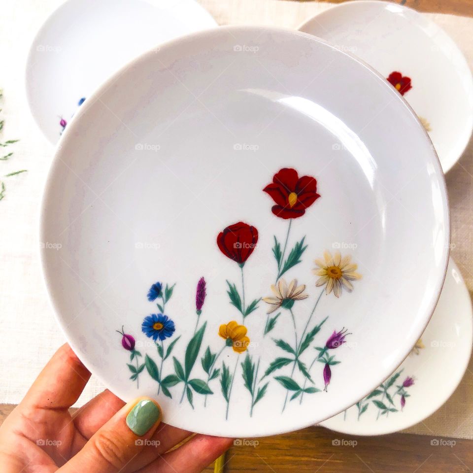 Old porcelain plate with meadow flowers pattern