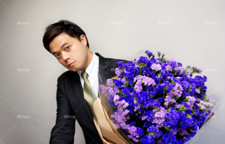 Man with violet flower