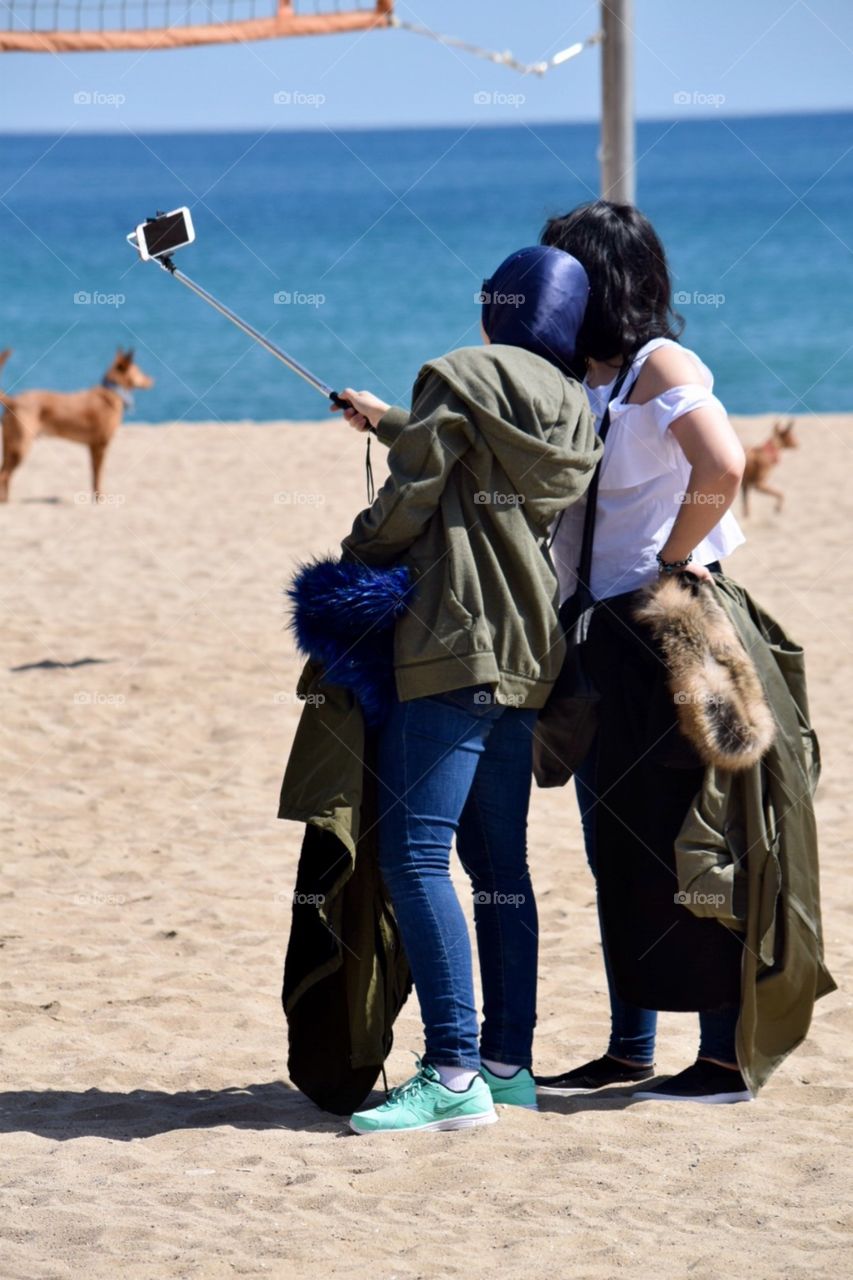 Girls taking selfies on the beach 