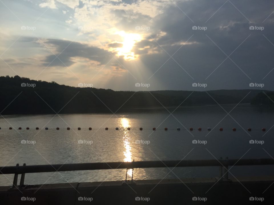 Sunset over lake on bridge