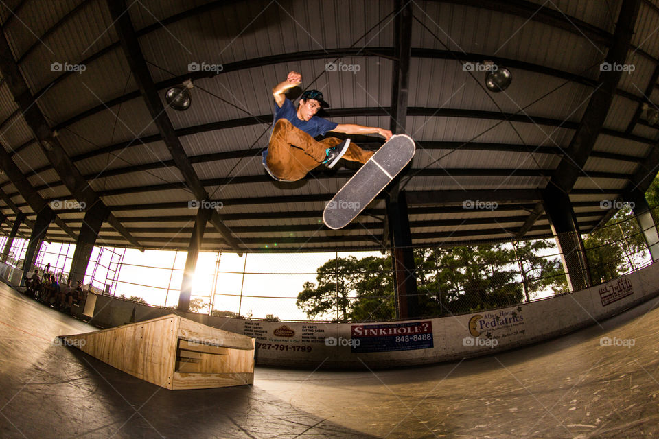 Skateboarder doing a trick off a ramp