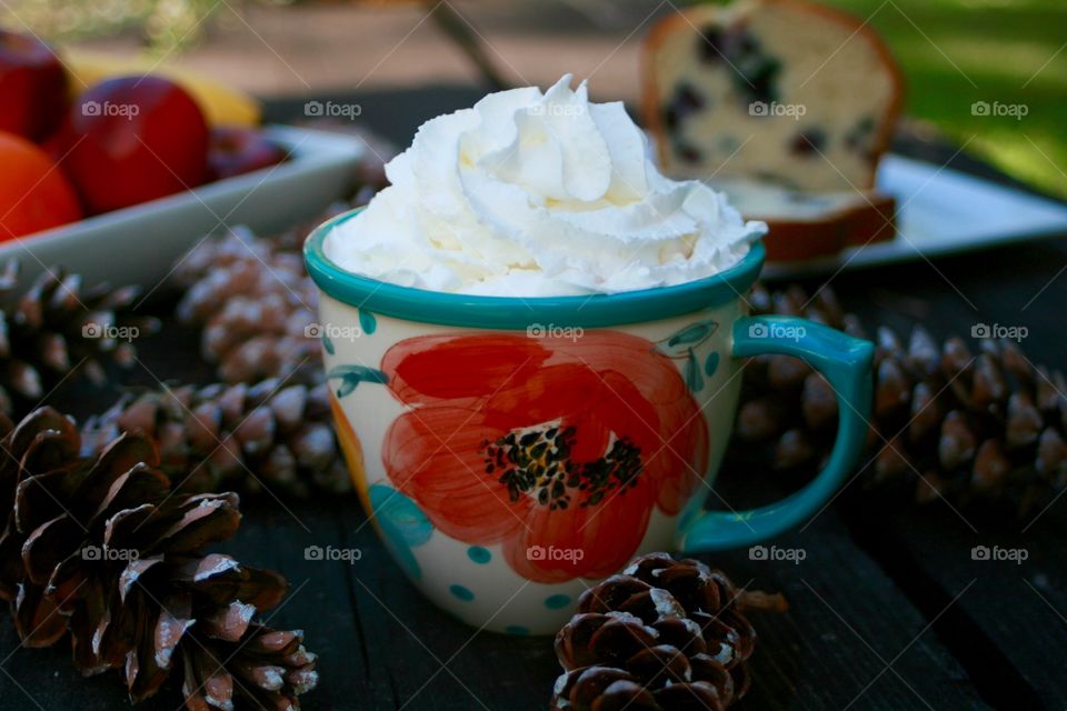 Hot chocolate with whipped cream on table