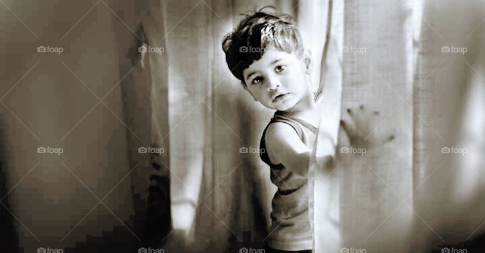 Give me light: Sweet boy near window feeling fresh with fresh morning.