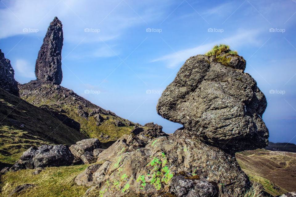In the background the Old Man of Storr looks over another equally, precariously balanced rock in the foreground 