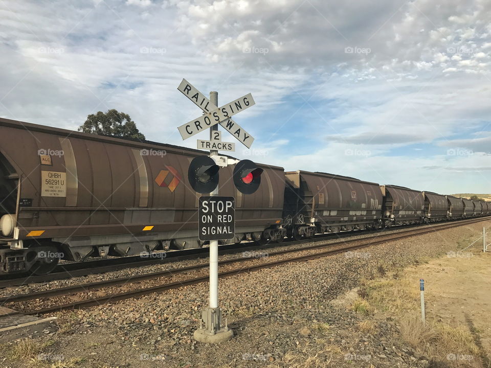 Coal train passing railway crossing
