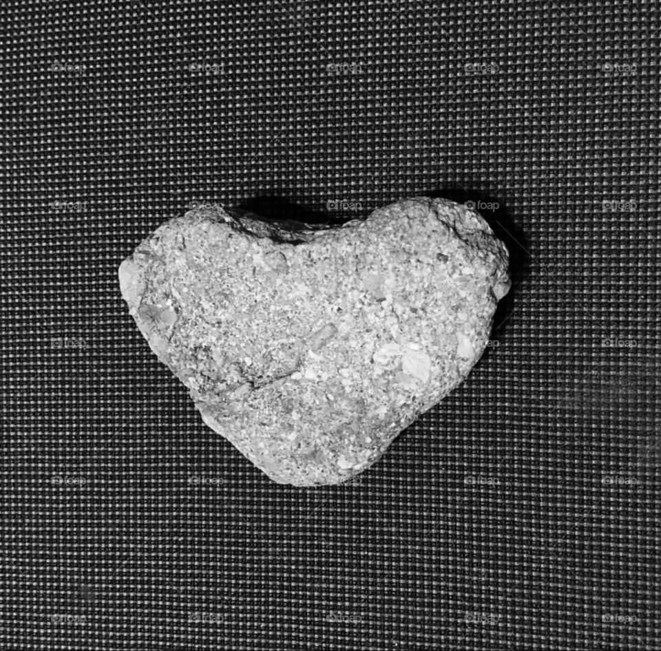 Heart shaped rock found in dirt.