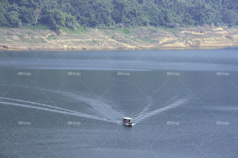 The tourist boat on water at Khun Dan Prakan Chon Dam ,Nakhon Nayok in Thailand