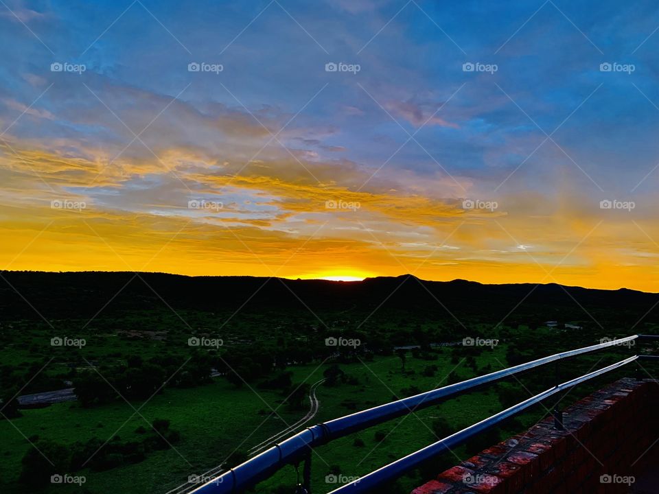 A beautiful sunset on a rainy day. A view from the rooftop. 