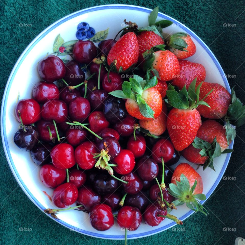 Cherry and strawberry on plate