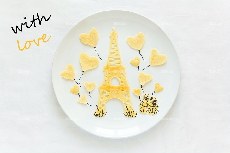 Food art. Eiffel tower and baloons with adults. Pancakes