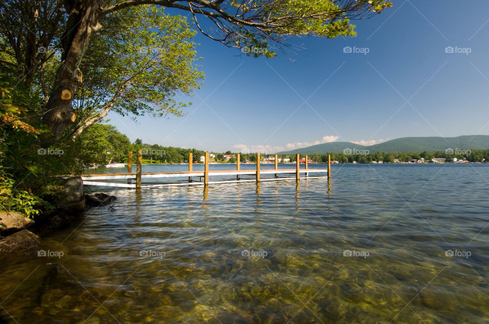 The dock juts out over the clear water in Center harbor bay