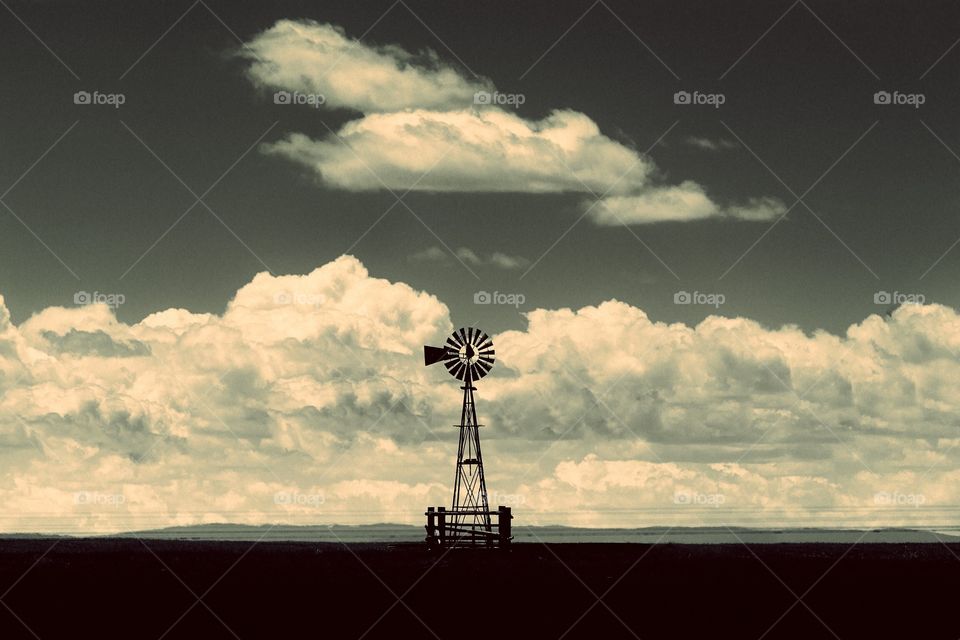 Against The Western Sky. Ranchers water windmill
