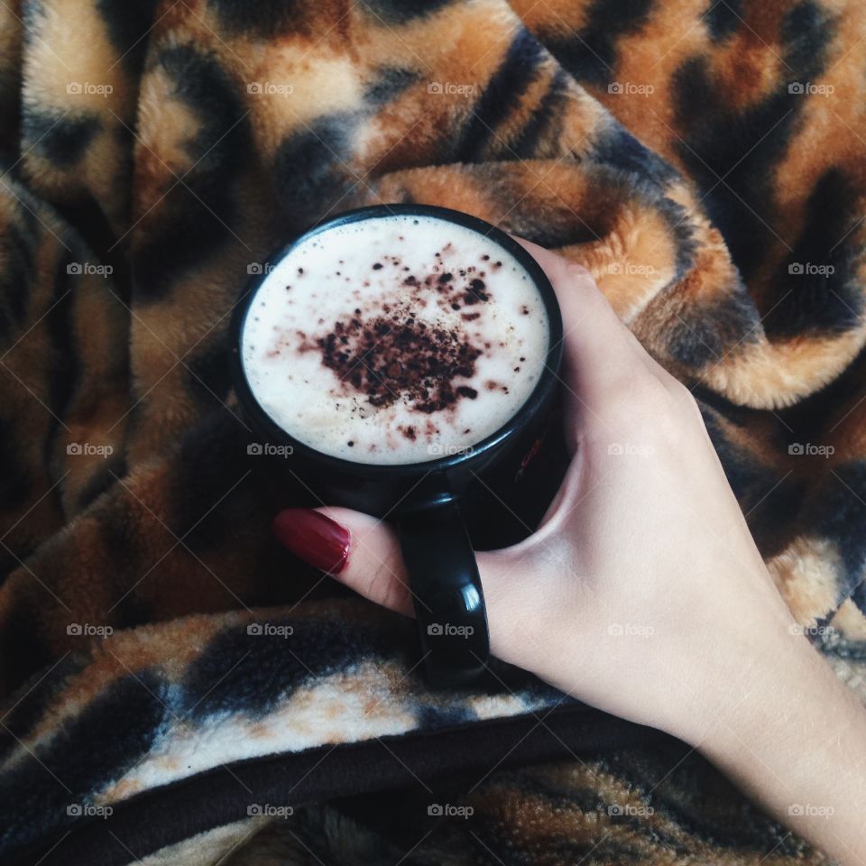 A person holding cup of coffee