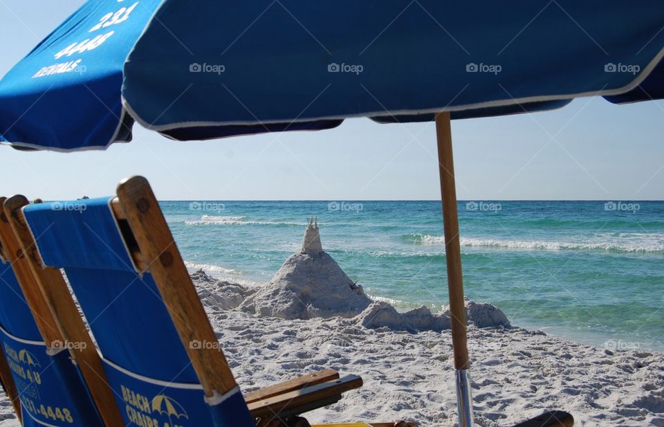 Umbrella sandcastle ocean 