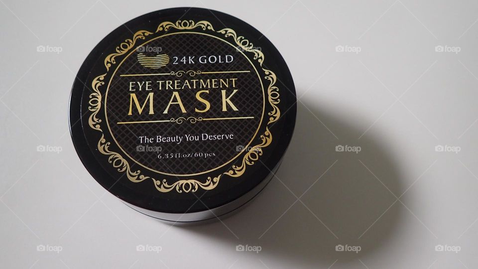 Beauty product I love Gold Eye Treatment Masks closeup product simple colors white background 