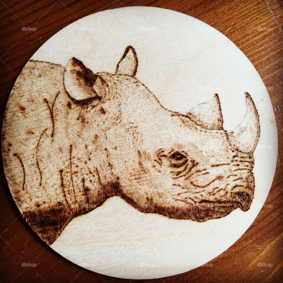 A rhino design drawn and burned by hand.
