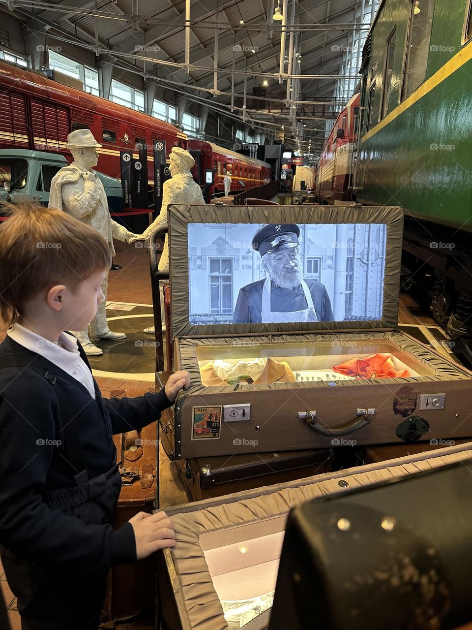 red-haired boy watching a movie in the museum