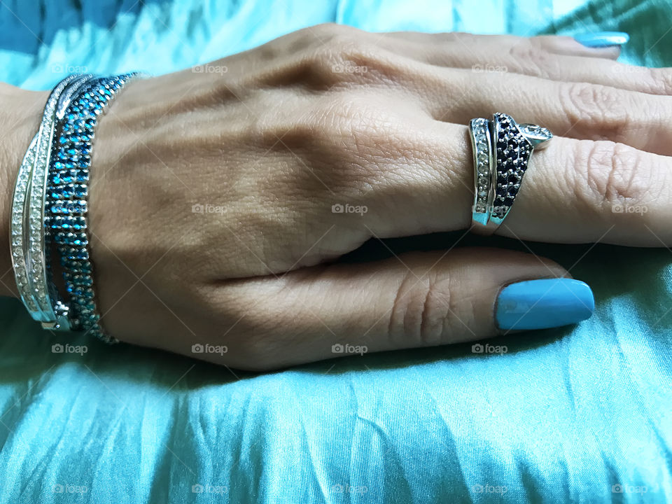 Blue manicure and jewelry 