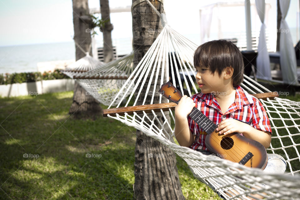 Young guitarist. relaxing on a hammock