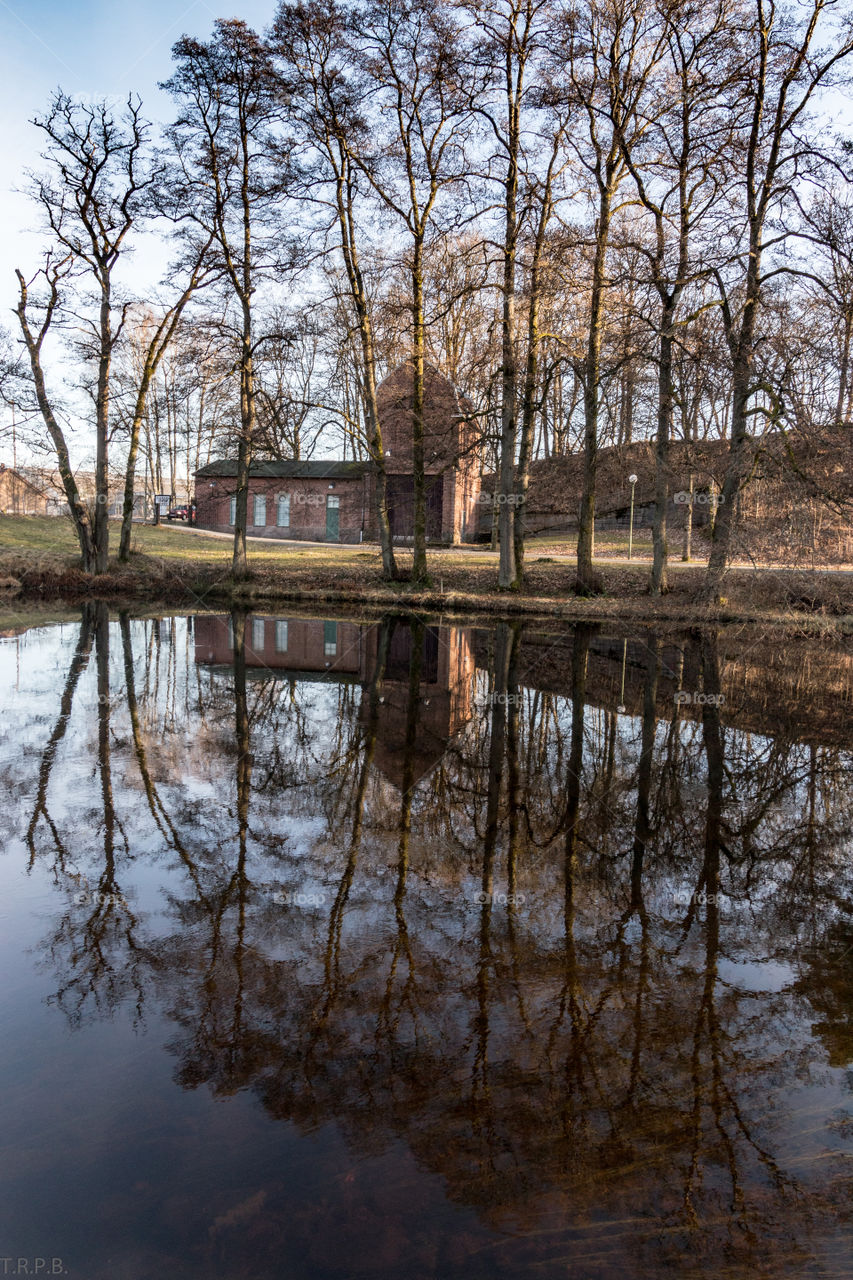 1800s Swedish brick building reflecting on the river