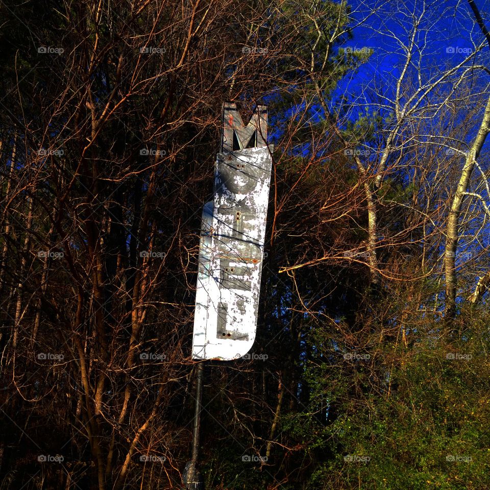 old abandoned motel sign. the motel is no where to be seen just the sign left. lonely and forgotten