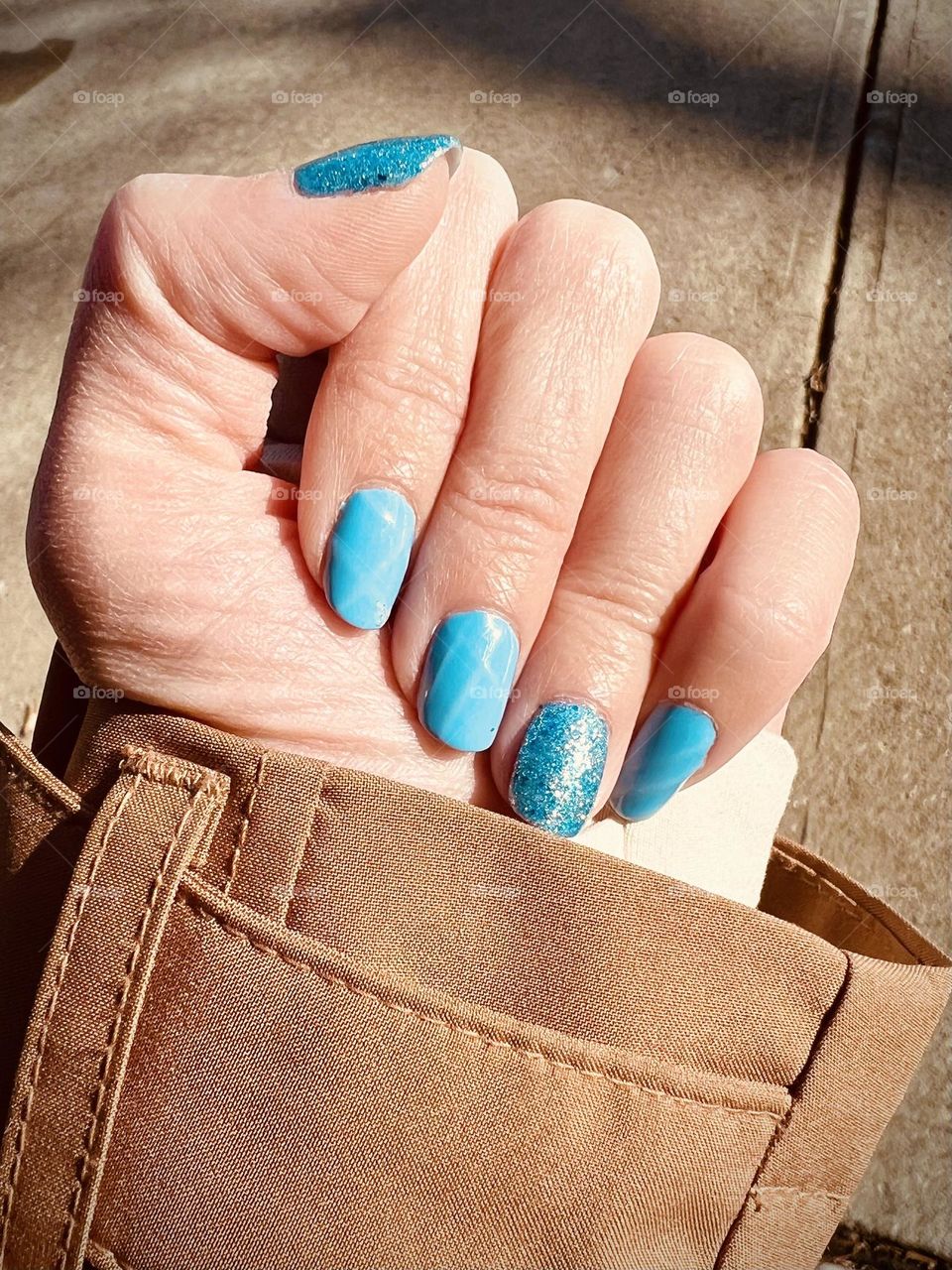 A bright blue gel nail polish manicure