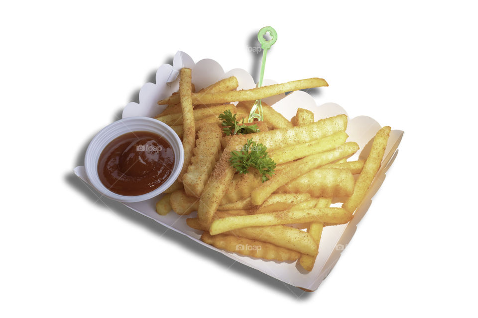 Isolated French fries and tomato sauce in the paper box on a white background with clipping path.