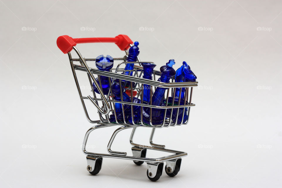 king,queen,rook,knight,bishop and pawn in a shopping cart