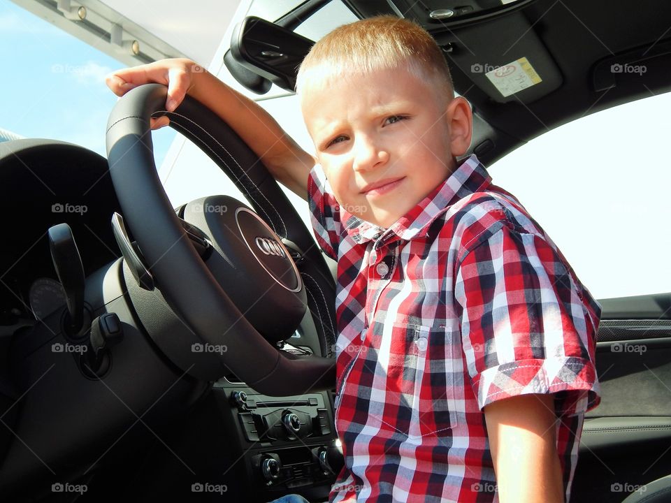 Boy sitting in car