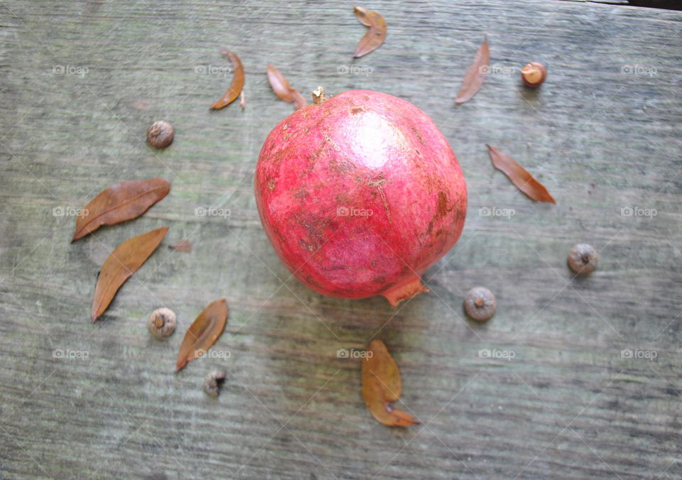 A pomegranate and leaves outside
