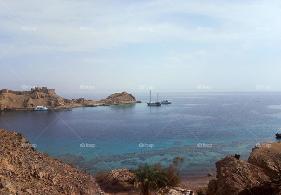 Beach , castle and mountains