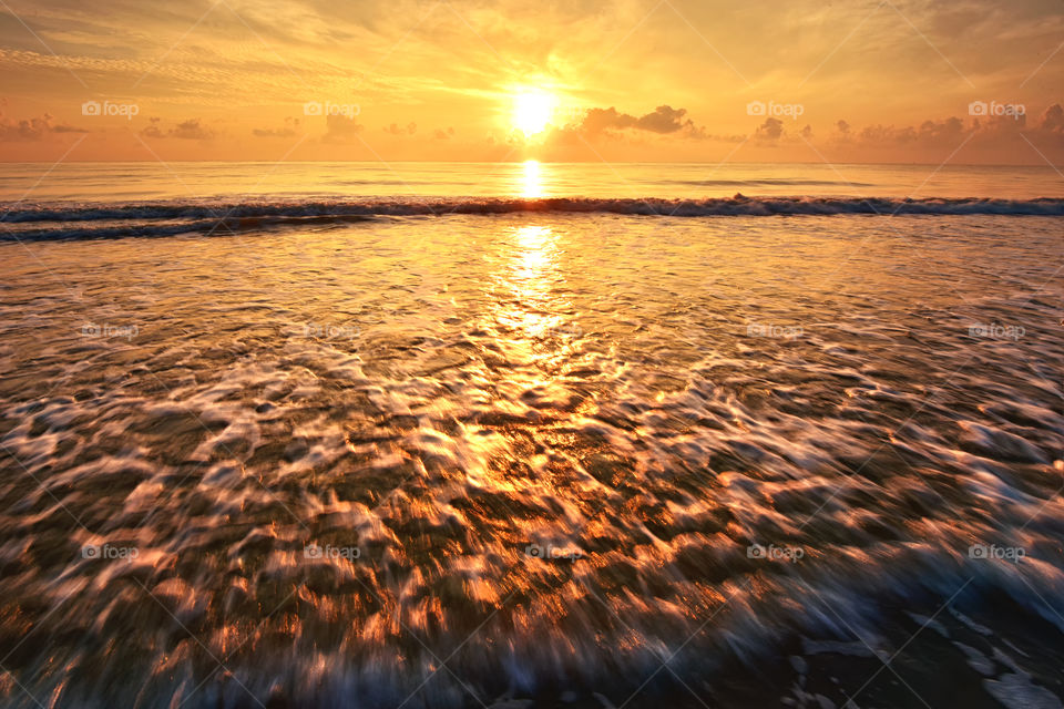 Beautiful golden sunrise over the beach
