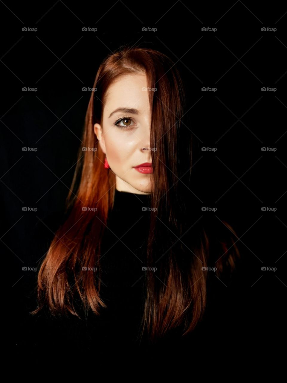 Young woman portrait. Red lips, long hair. Black and red. Brunette.