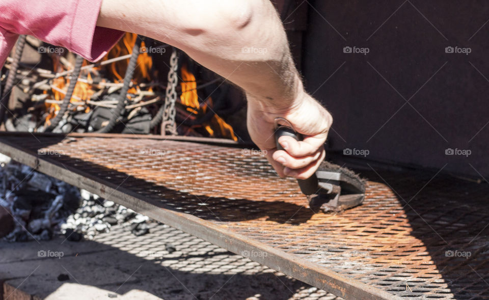 Cleaning the grill with scrubber