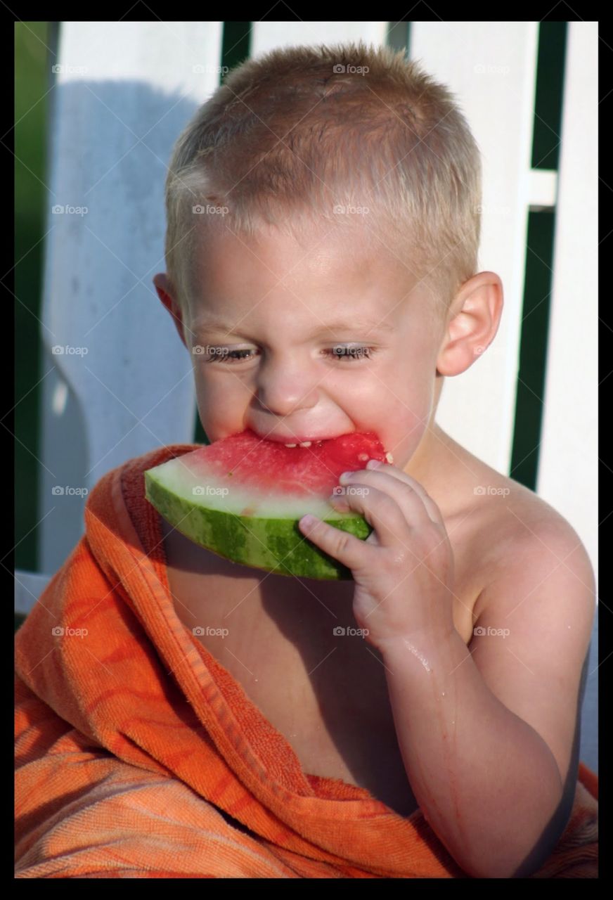 Boy eating watermelon slice