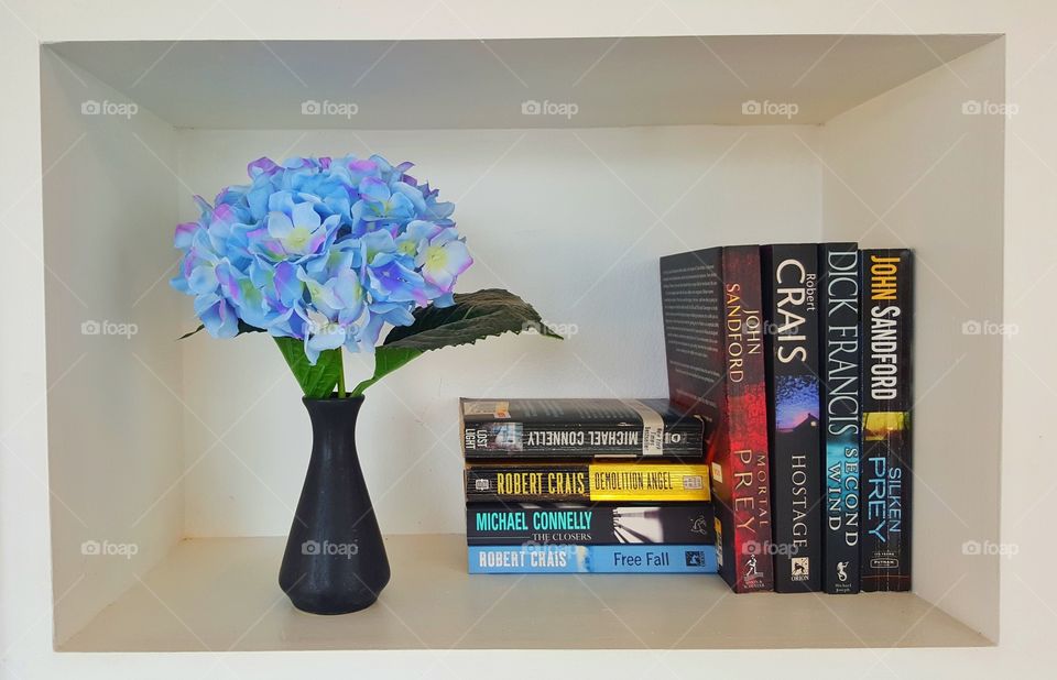 flower, vast & books on shelf. colorful flower in a vast and  books on shelf