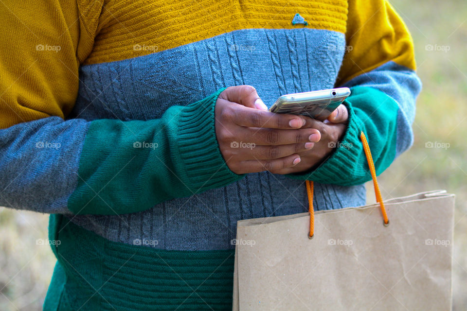 A girl using mobile in winter season, Smartphone shopping, Shopping,winter season, Holiday shopping, Sweater weather
