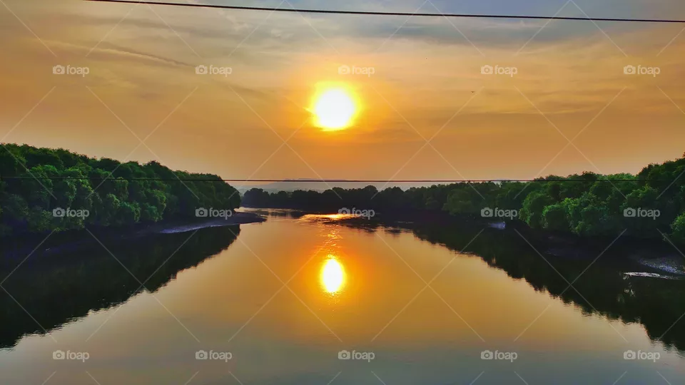 beautiful view of reflection of sun in water of river.