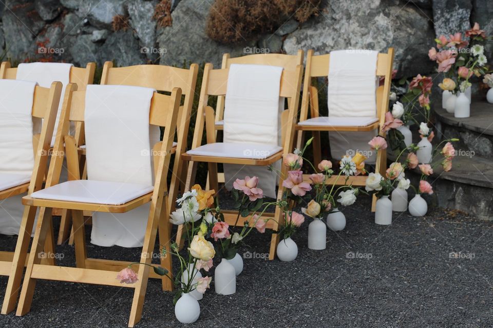 Chairs in a row with flower vases 